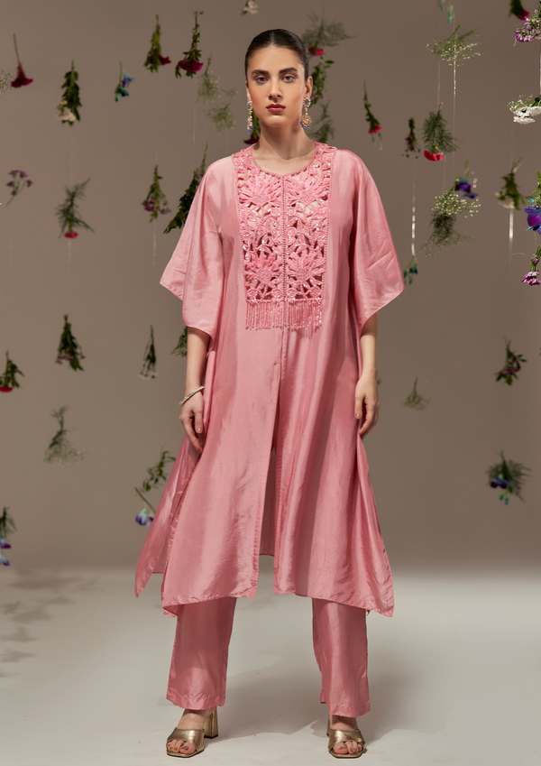 Long kaftan with intricate cutwork and slit in the center paired with straight Pants