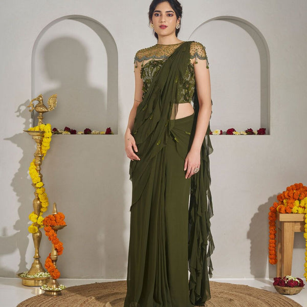 Vishnupadi -<br>Draped georgette saree with a frilled pallu, styled with a 3D wildflower-embroidered net corset and an embellished net bib detailed with tassels