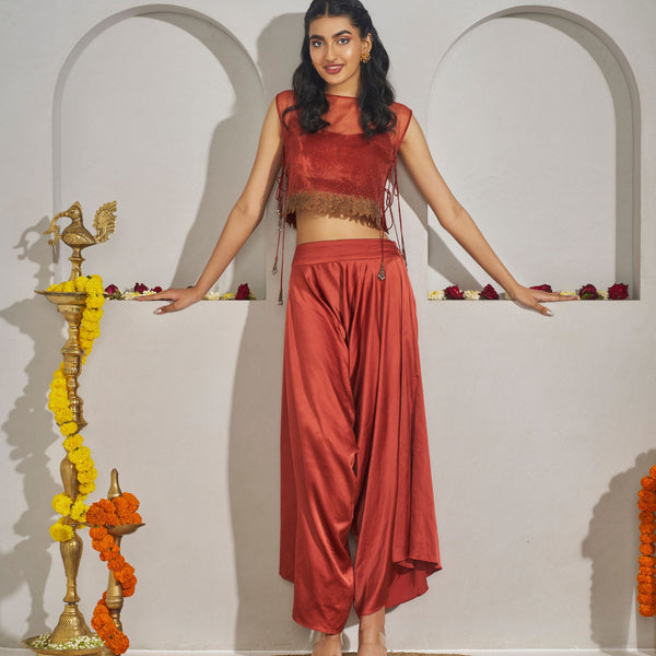 Pavani -<br>Draped satin-silk dhoti pants with a bustier, layered with a sleeveless organza cape featuring threadwork, beadwork, and delicate side tie-ups