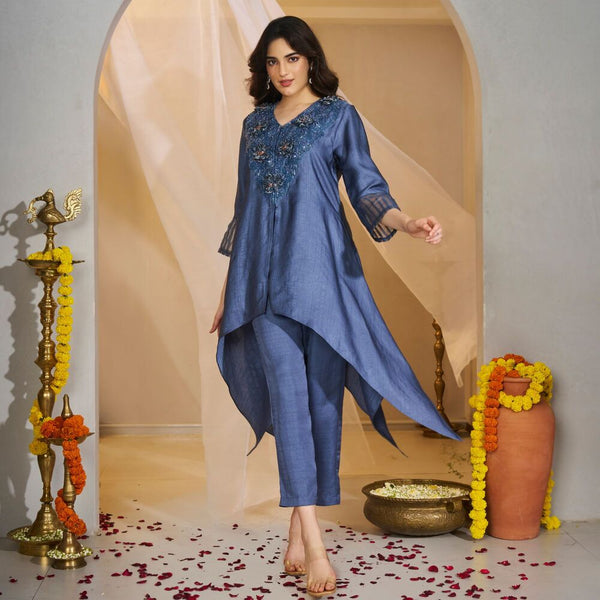 Shivpriya - <br>Symmetrical tunic adorned with 3D velvet florals and beadwork on the neckline, paired with matching pants