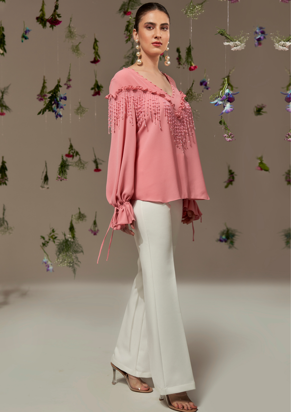 Top with frill and gathered tie-up sleeves with tassels on the neckline