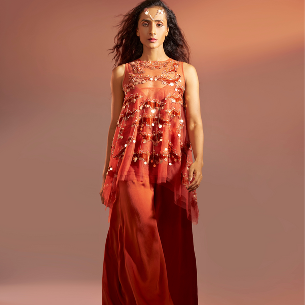 Ganga - <br>3-layered net high-low tunic with velvet appliqué and metallic tassels, styled with a bustier and silk satin pleated palazzos